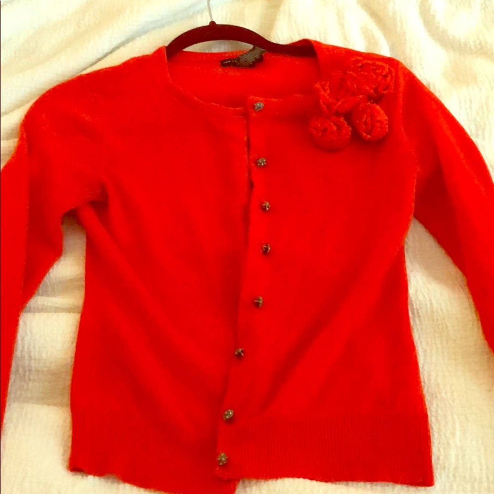 Orange sweater with rhinestone buttons